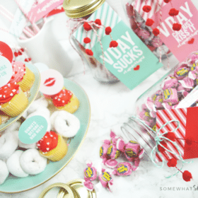 setting up a galentines day party with colorful printables and mini donuts