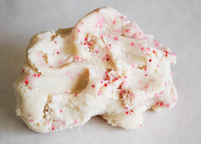 Raw shortbread cookie dough with pink, red and white sprinkles