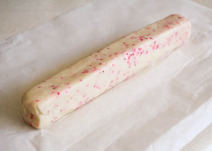 Raw Valentine Shortbread Cookie Dough in a log shape on parchment paper