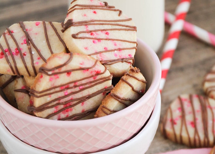 Valentine Shortbread Cookies drizzled with chocolate in a pink bowl