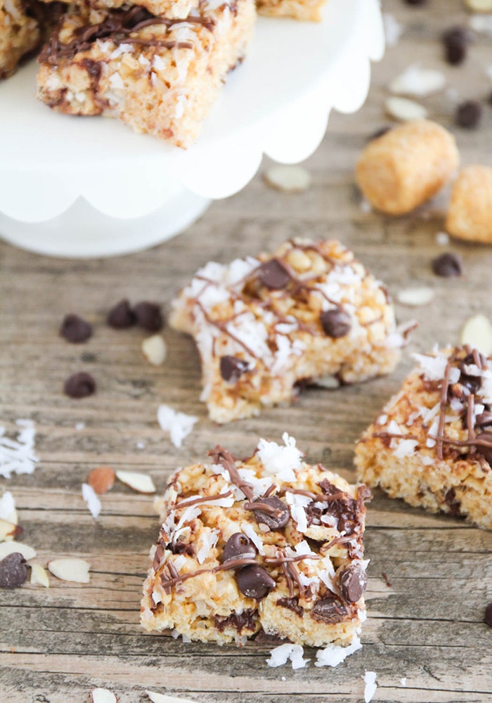 rice krispie treats topped with coconut chocolate and almonds