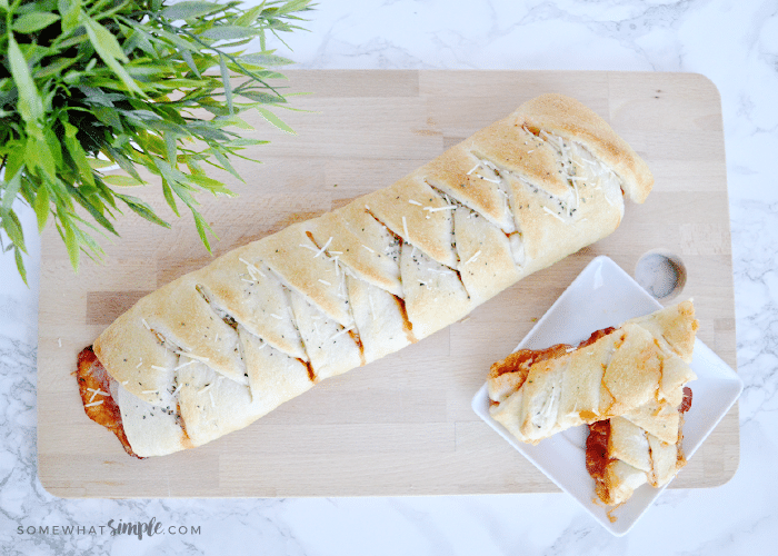 looking down on a calzone laying on a cutting board made from this easy calzones homemade pizza