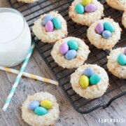 Birds Nest Cookies next to a glass of milk with two paper straws