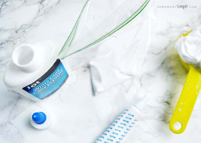 looking down on glue and shaving cream on a counter which are supplies to make homemade puffy paint