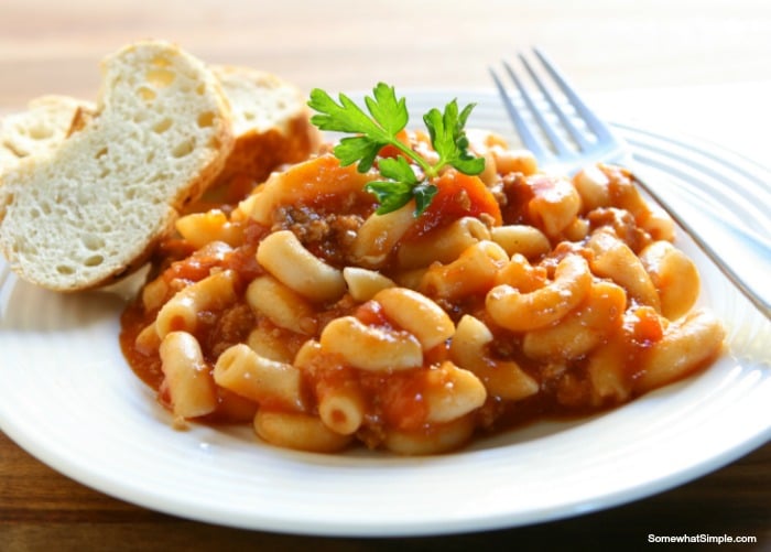 a plate of chili mac and a slice of bread
