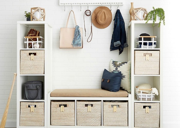 various wooden shelves with bins inside each compartment for storage