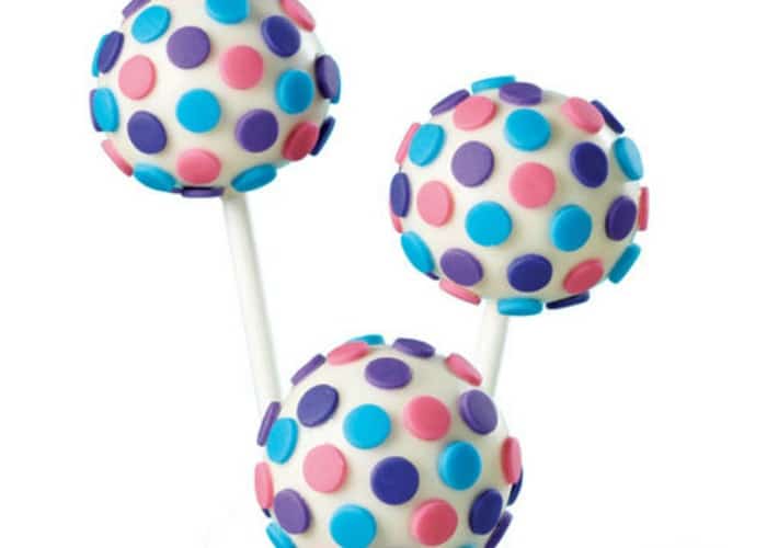 three fondant cake pops with blue and pink pastel colored polka dots