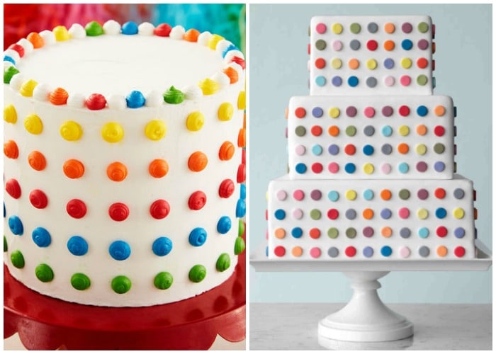 two large cakes with white frosting that have brightly colored polka dots