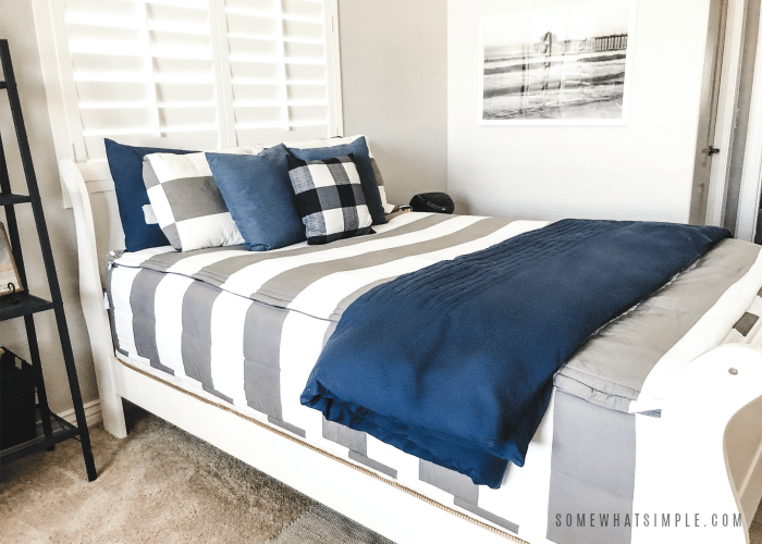 teen boy bedding - gray and white striped bedding with navy blue throw