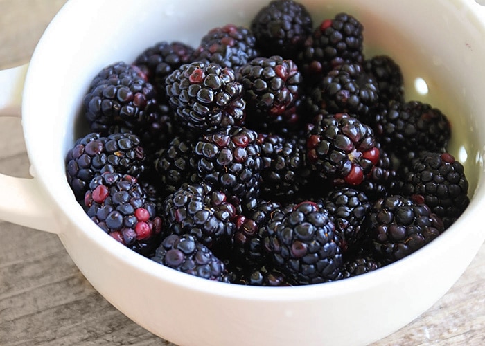 a bowl filled with fresh blackberries
