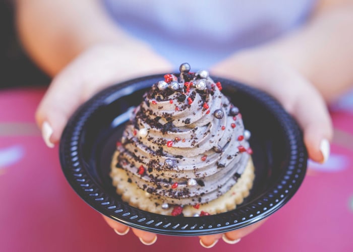 a ice cream topped cookie in a black bowl