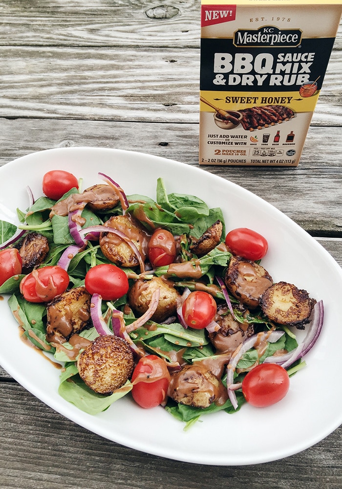 a salad with potatoes and tomatoes with dry rub seasoning