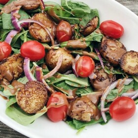 a potato arugula salad with a vinaigrette dressing