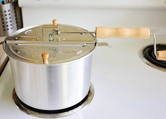 a whirley pop pot on a stove