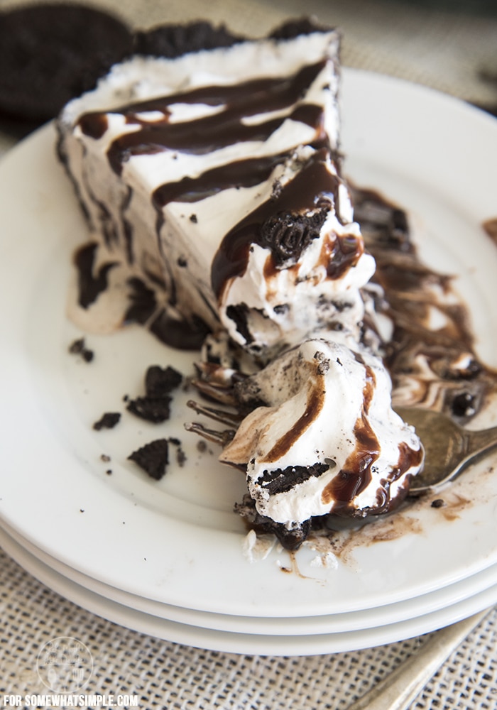 A slice of oreo ice cream pie drizzled with hot fudge