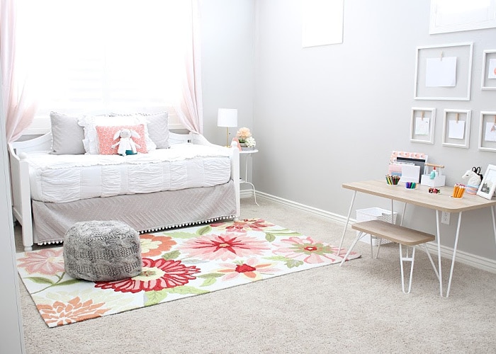 a little girl's bedroom that's been decorated with light pink colors