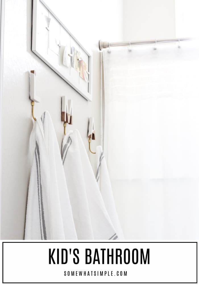 Our upstairs kid's bathroom gets a simple gray and white makeover that is clean, comfortable, fresh and fun!  This decor ideas are an easy and inexpensive way to refresh your bathroom. #bathroom #decor #kidsbathroom #kidsbathroomideas #bathroomdesign #kidsbathroomdecorideas #sharedkidsbathroomideas via @somewhatsimple