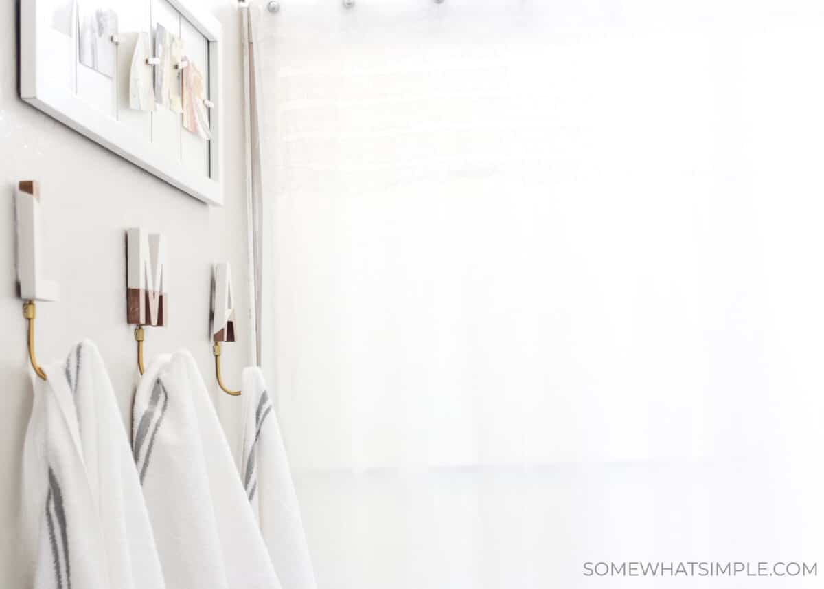 towels hanging from individual monogram towel racks