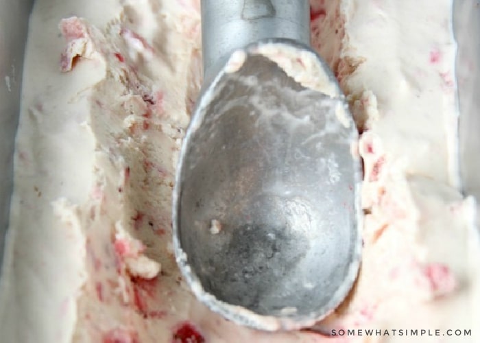 ice cream scoop in homemade strawberry ice cream