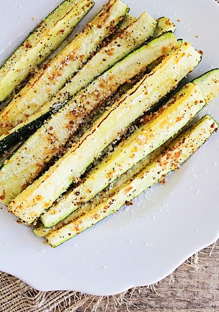 Baked Parmesan Zucchini wedges on a serving plate