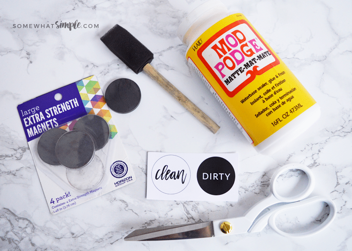 a bottle of Mod Podge, circular magnets, a foam paint brush, scissors and the clean or dirty free printable