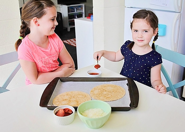 kids making a tortilla pizza