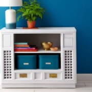 an upcycled tv cabinet turned into a shelf with baskets