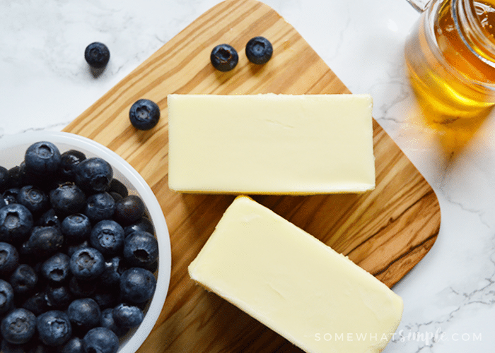 looking down on a cutting board with the ingredients to make blueberry honey butter