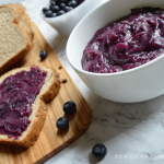blueberry honey butter in a small white dish wiht buttered toast in the background