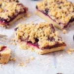 squares of Cherry Streusel Bars on a baking sheet