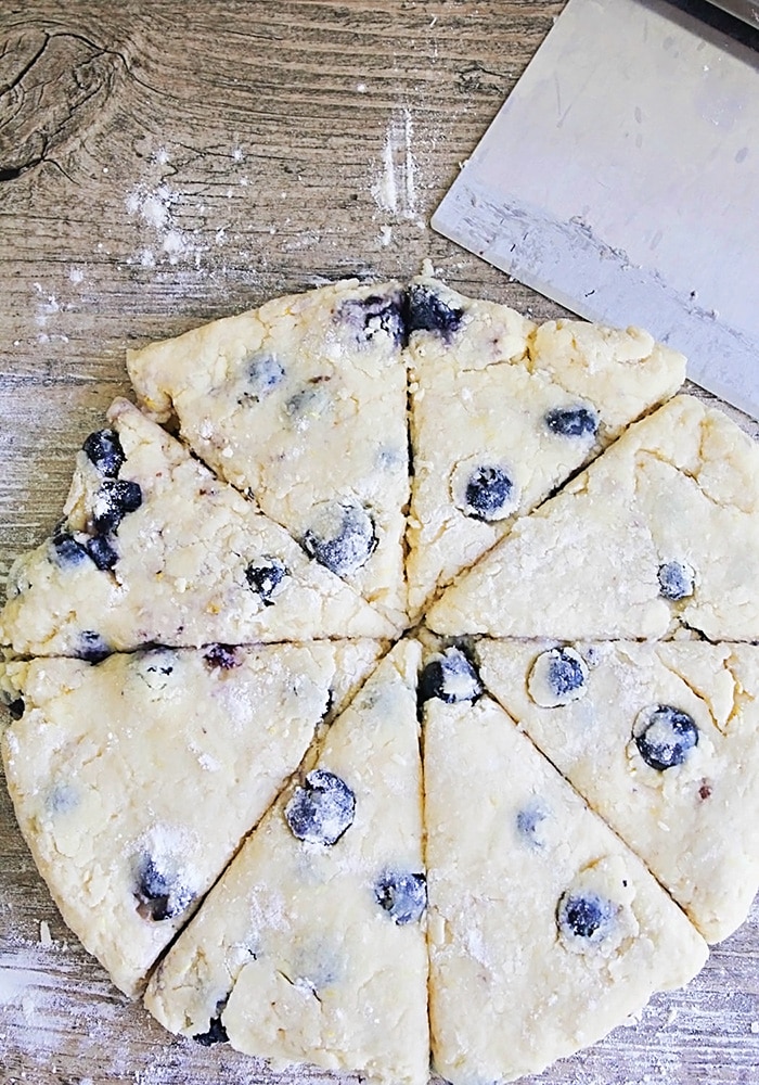 dough with blueberries cut into wedges