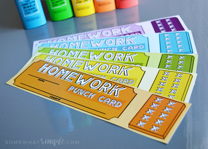 multi-colored Homework punch card bookmarks from this free download are fanned out on top of a counter