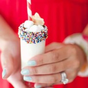 someone holding a milkshake shooter mocktail drink