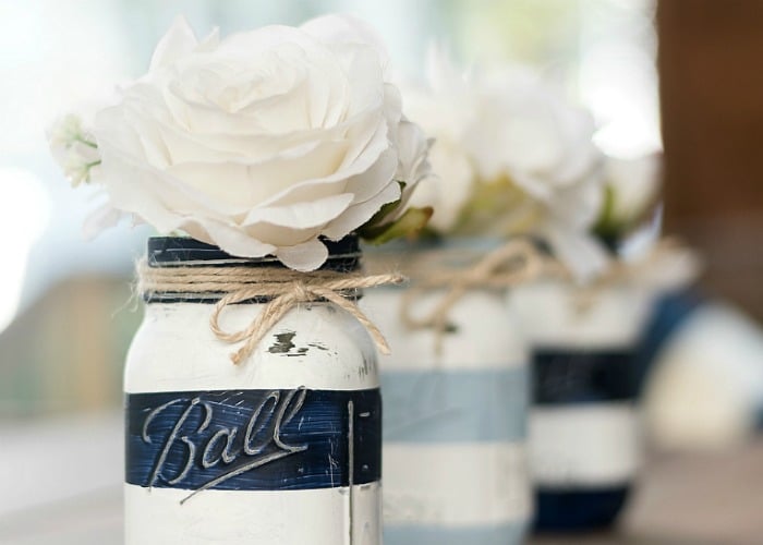 a centerpiece with a white flower in a Ball jar 