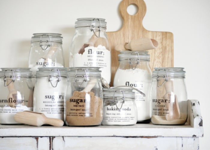 Mason Jar filled with baking ingredients on a shelf with labels on them are a cute farmhouse Decor idea