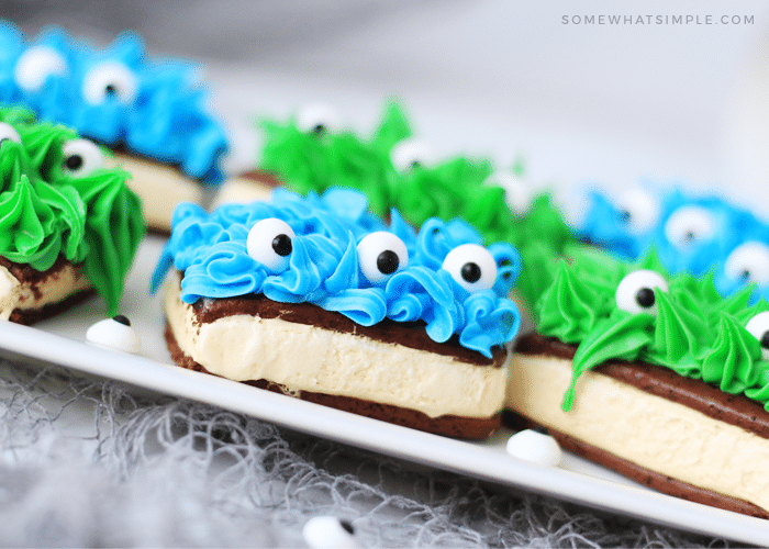 ice cream sandwich monsters made with blue and green frosting and candy eyes