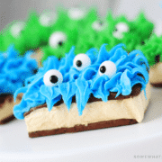 ice cream sandwich monsters made with blue and green frosting and candy eyes