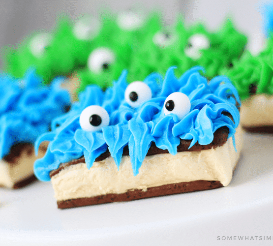ice cream sandwich monsters made with blue and green frosting and candy eyes