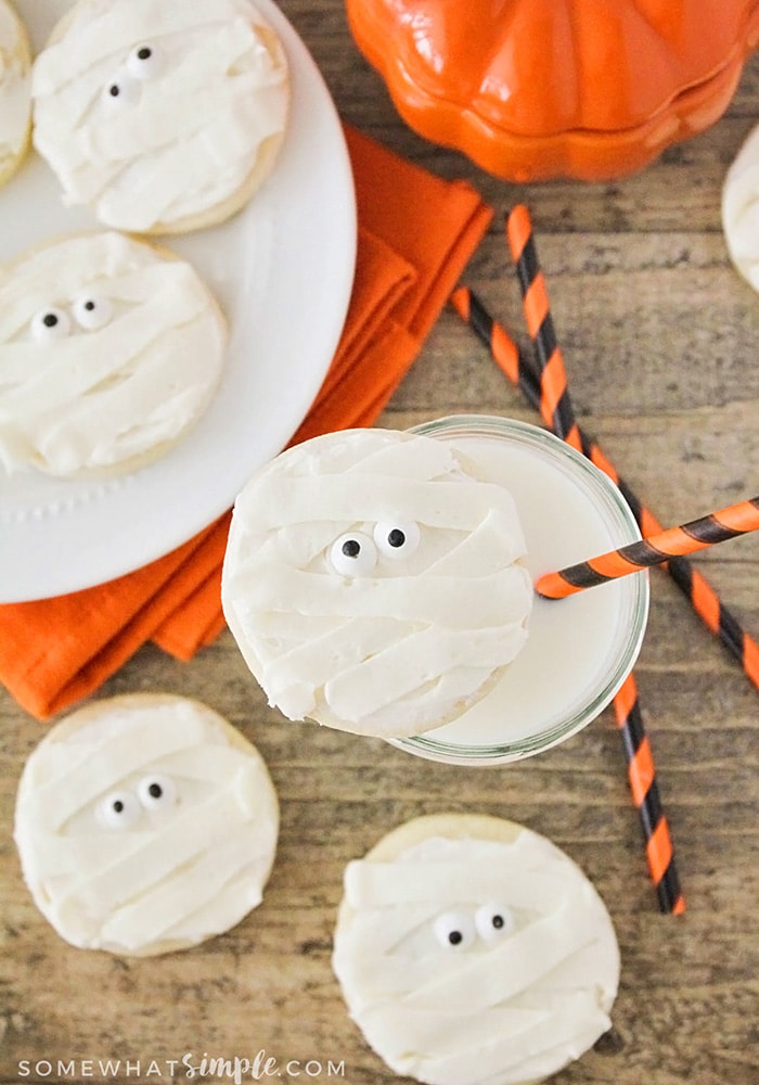 Looking down on several sugar cookies that are decorated to look like a mummy face