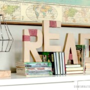 yarn wrapped letters on a book shelf that spell out the word read