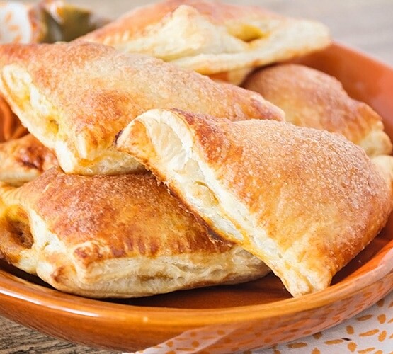 Pumpkin Pie Turnovers on an orange plate