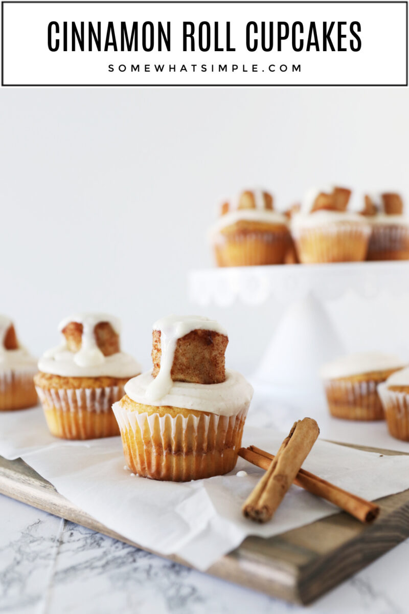 cinnamon roll cupcakes next to 2 cinnamon sticks