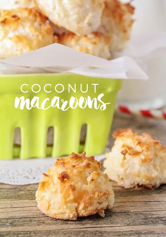 Basket of coconut macaroons with two sitting on the counter