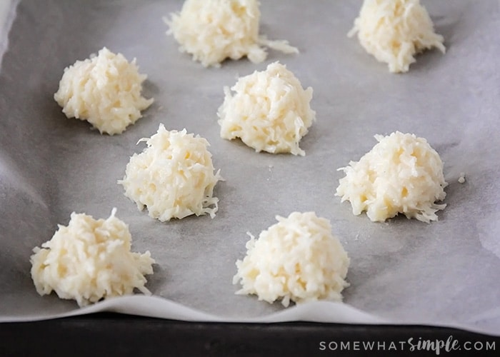 adding drops of macaroon mixture onto a baking sheet