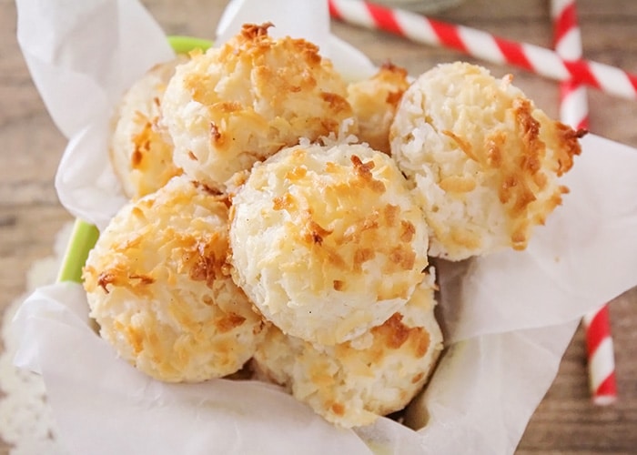 basket of coconut macaroons on the counter next to 2 striped red straws