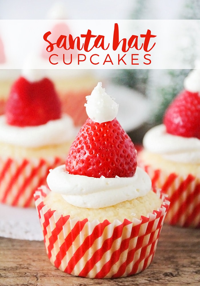 Santa hat cupcakes are a fun and festive dessert to serve during the Christmas holidays.  Topped with a fresh strawberry and homemade frosting, you won't be able to just eat one of these cupcakes. These are the perfect festive dessert idea to serve at your next Christmas party. via @somewhatsimple