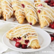 a cranberry scone with white chocolate drizzled on top