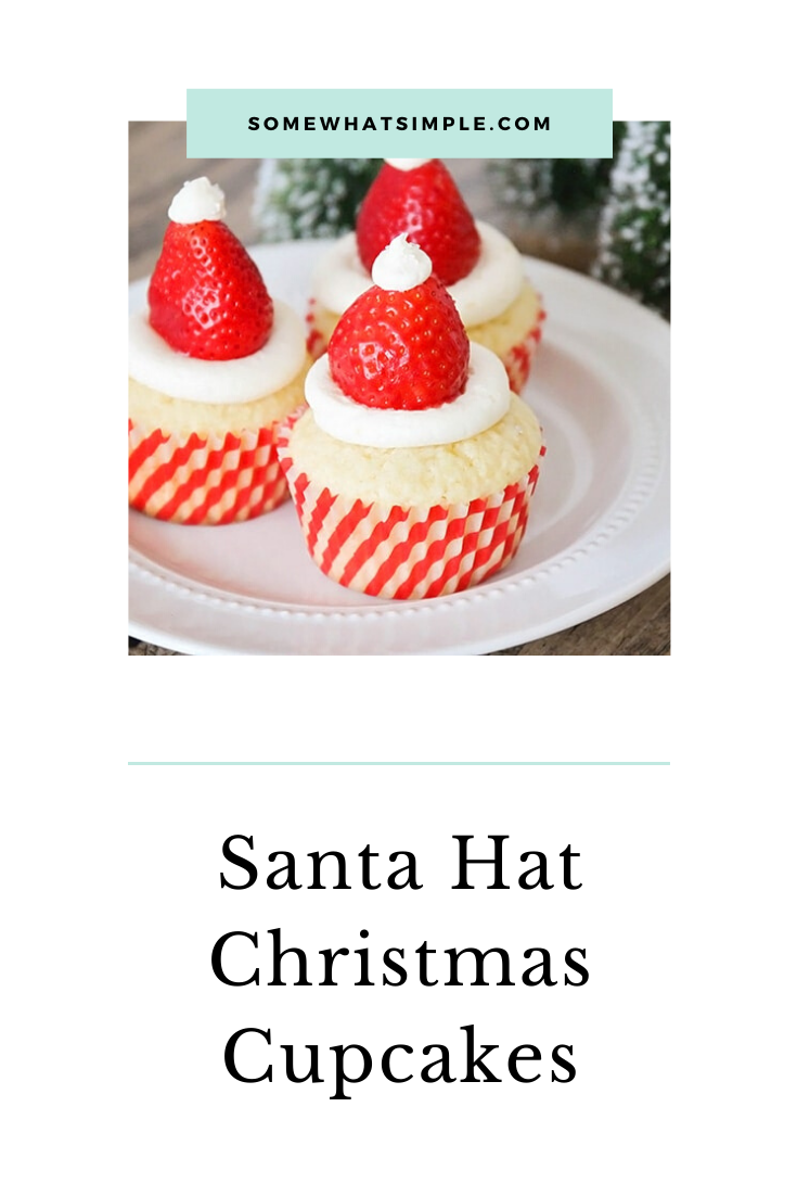 Santa hat cupcakes are a fun and festive dessert to serve during the Christmas holidays.  Topped with a fresh strawberry and homemade frosting, you won't be able to just eat one of these cupcakes. These are the perfect festive dessert idea to serve at your next Christmas party. via @somewhatsimple