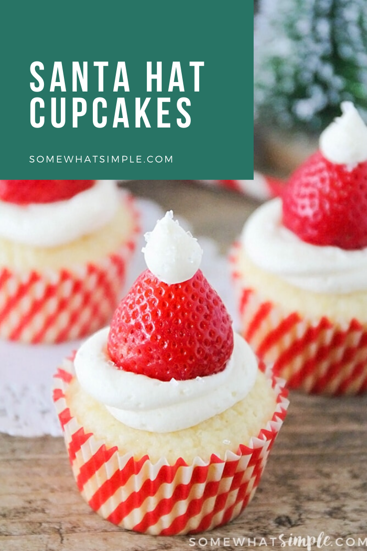 Santa hat cupcakes are a fun and festive dessert to serve during the Christmas holidays.  Topped with a fresh strawberry and homemade frosting, you won't be able to just eat one of these cupcakes. These are the perfect festive dessert idea to serve at your next Christmas party. via @somewhatsimple