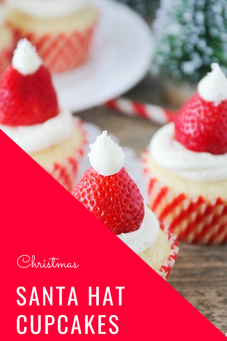 Santa hat cupcakes are a fun and festive dessert to serve during the Christmas holidays.  Topped with a fresh strawberry and homemade frosting, you won't be able to just eat one of these cupcakes. These are the perfect festive dessert idea to serve at your next Christmas party. via @somewhatsimple